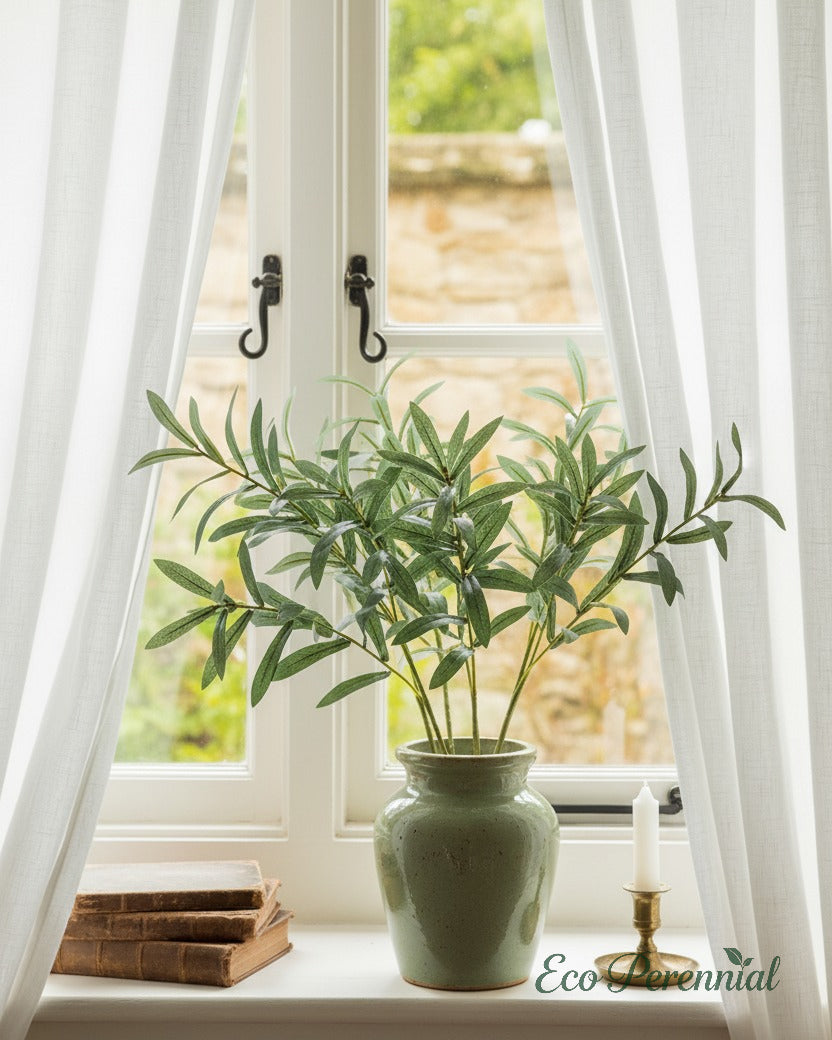 Eco Perennial realistic artificial olive branch centerpiece in a linen-textured vase on a living room console table