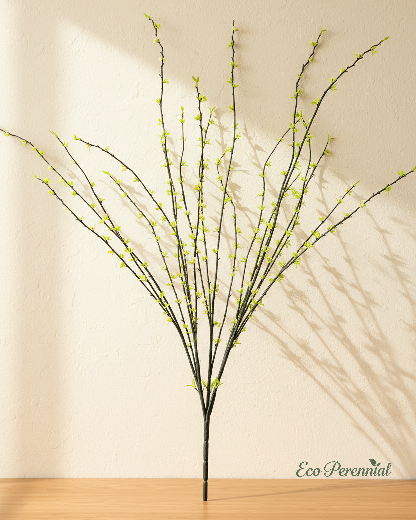 Faux snow willow branch in a decorative ceramic vessel
