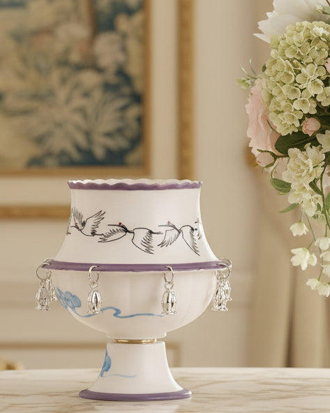 Whimsical crane spinning ceramic teacup with purple trim and silver bell charms by Eco Perennial