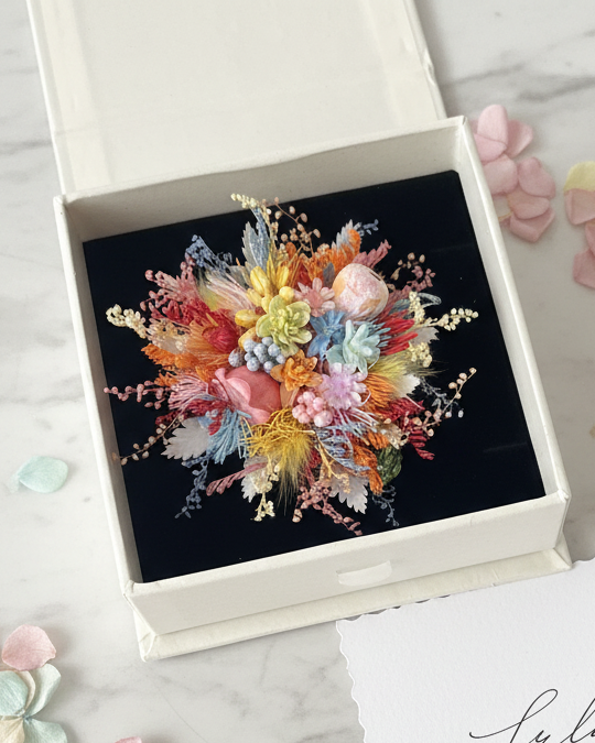 Wildflower preserved flower ring worn on hand with pink bokeh background — Eco Perennial