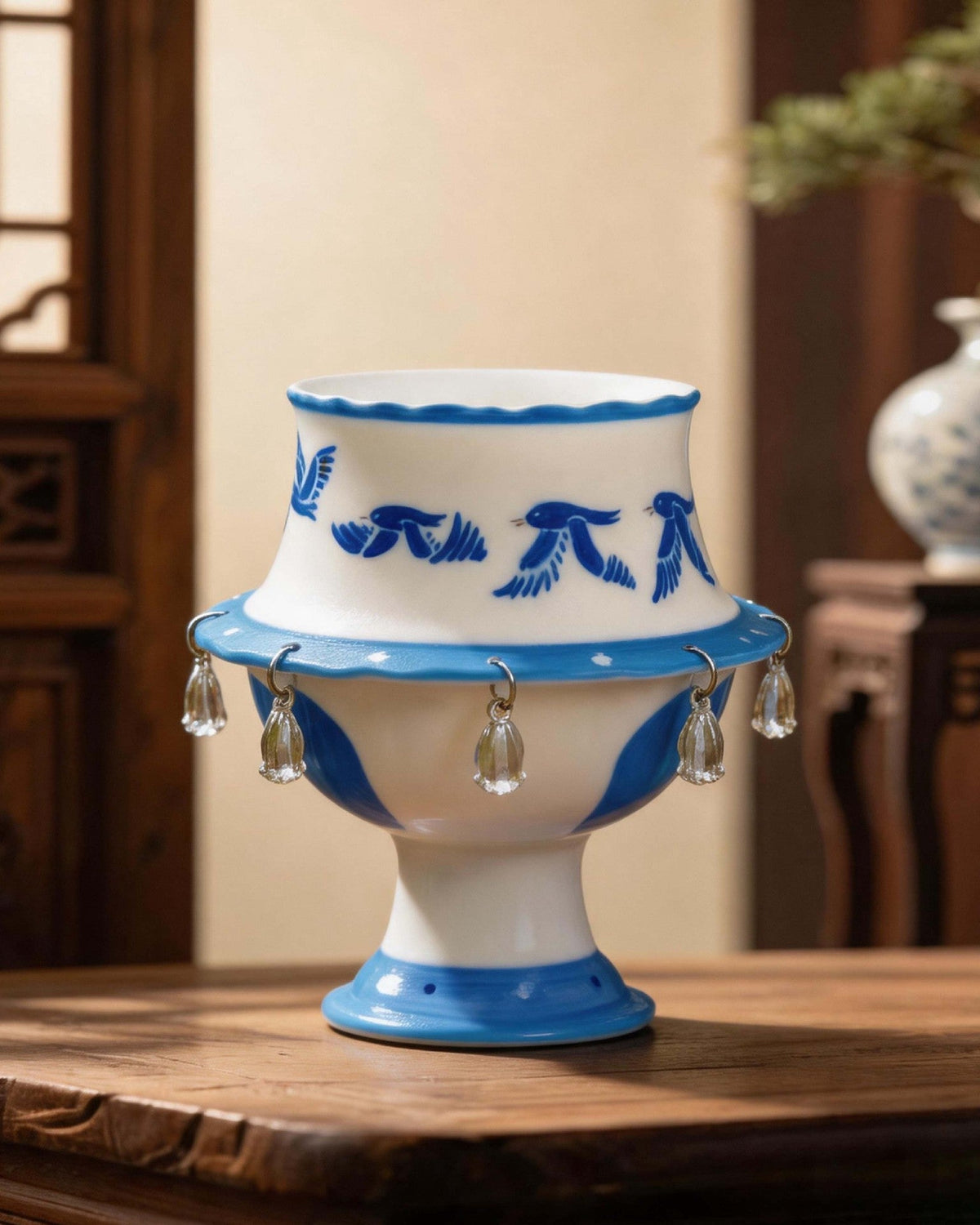 Flying Bird Spinning Ceramic Cup — handcrafted blue and white ceramic rotating teacup with crystal pendants