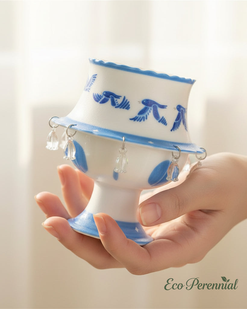 Blue and white spinning ceramic cup with crystal teardrop pendants — handcrafted artisan teacup