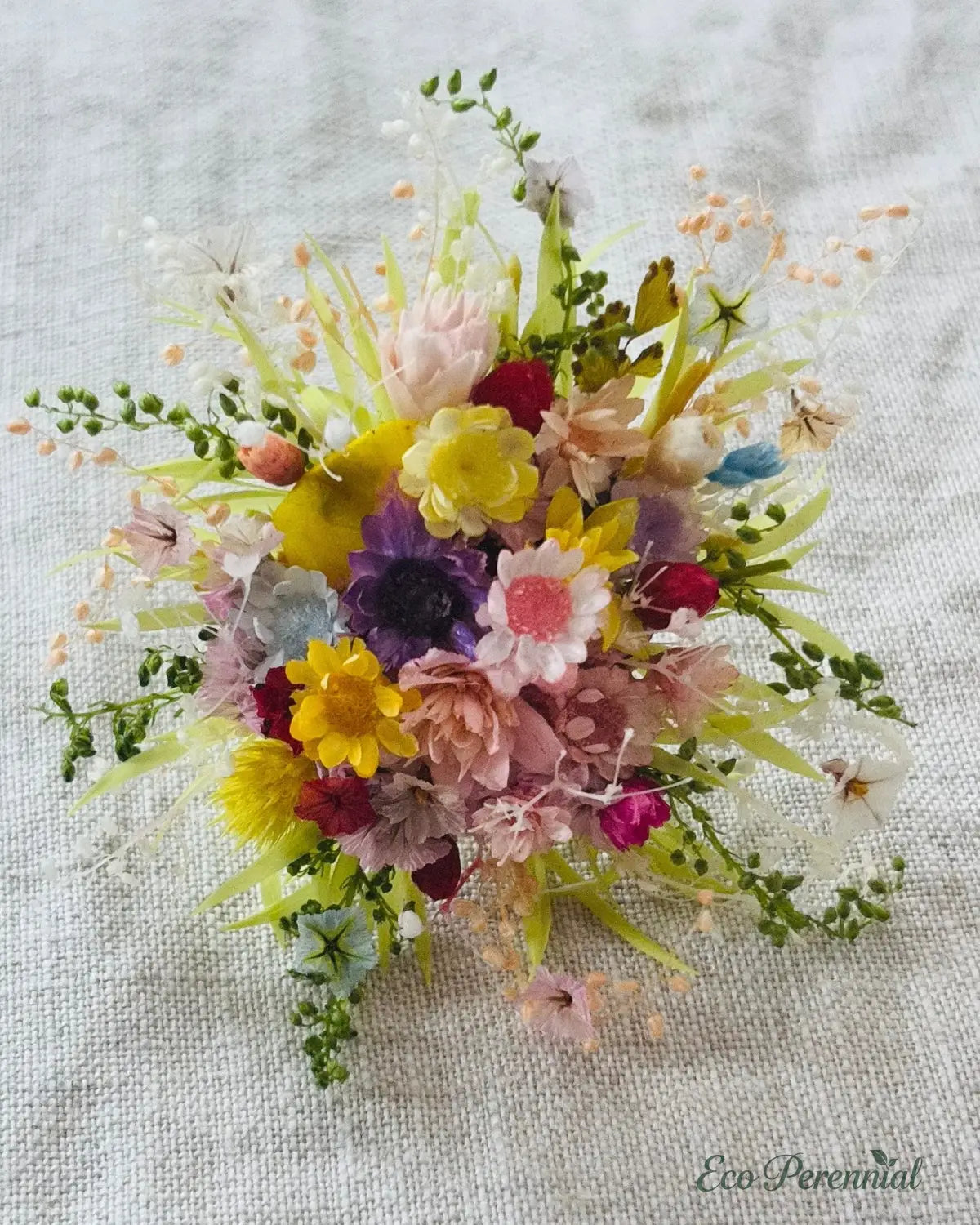 Colorful flower arrangement on a textured fabric background